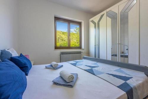 a bedroom with a large bed with towels on it at Apartment Klaudia in Dramalj