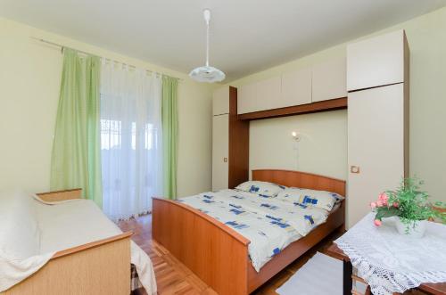 a bedroom with a bed and a desk and a bed at Apartment Anica in Kampor