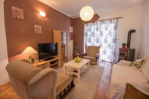 a living room with a couch and a tv at Apartment Sanja in Rab
