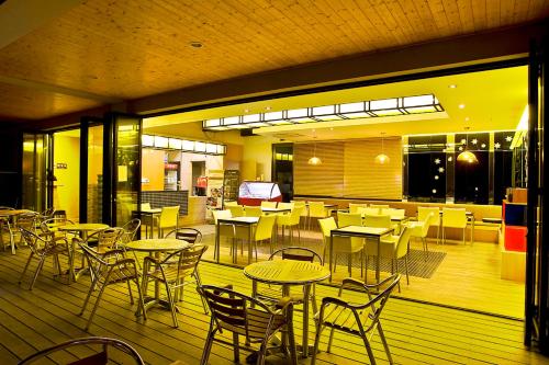 a restaurant with tables and chairs on a deck at Hyundai Soo Resort Hoengseong in Pyeongchang