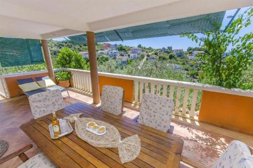 a table and chairs on a balcony with a view at Apartments Otjana in Sevid