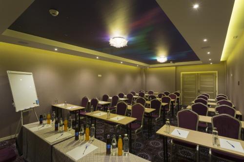a room with rows of tables and chairs in a room at Exclusive Hotel & More in Sibiu