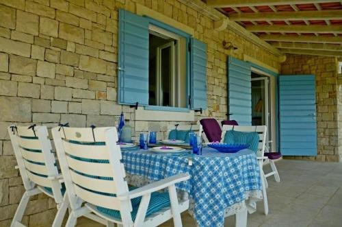 a table with a blue table cloth on a patio at House Nevena in Postira