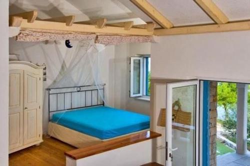 a bedroom with a bed with a canopy in it at House Nevena in Postira