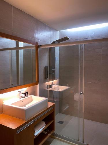 a bathroom with a sink and a shower at Vogue Inn at Hualien in Hualien City