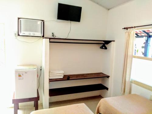 En eller flere senge i et værelse på Suítes a 50 metros da Rua das Pedras