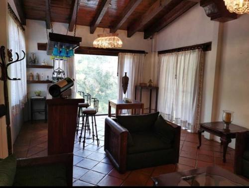 a living room with a couch and a table at Alojamiento Cúpulas Avandaro in Valle de Bravo
