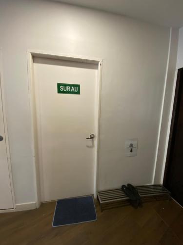 a white door with a sign that reads surfadj at D'Green Hotel Kuching in Kuching