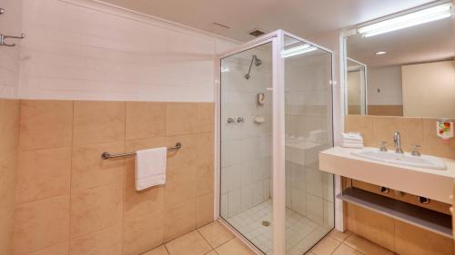 a bathroom with a shower and a sink at City Reach Motel in Wangaratta
