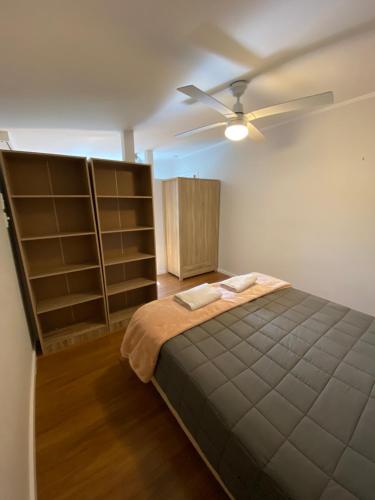 a bedroom with a bed and a ceiling fan at Featherston Motels And Camping in Featherston