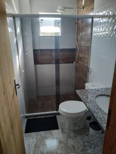 a bathroom with a shower and a toilet and a sink at Flat Solife 2 Cabo Frio-Búzios in Cabo Frio