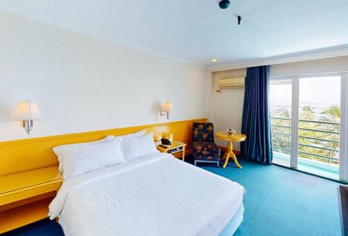 a hotel room with a bed and a balcony at Aloha Hotel Roxas Boulevard Manila in Manila