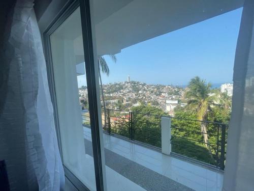 a balcony with a view of a city at Loft 208 in Acapulco