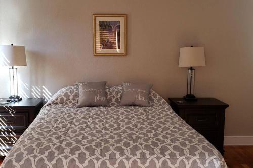 a bedroom with a bed with pillows and two lamps at Southside Jax great home RV parking in Jacksonville