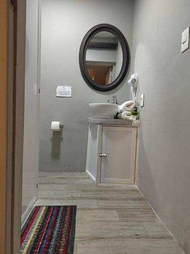 a bathroom with a sink and a mirror at 10th ave Suite in Cozumel