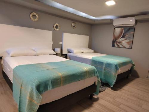 a room with two beds in a room at 10th ave Suite in Cozumel