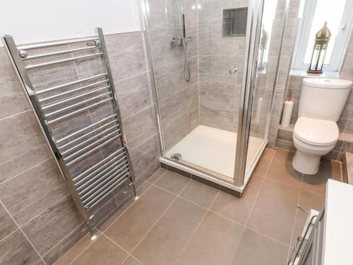 a bathroom with a shower and a toilet at Lightkeeper House in Amble