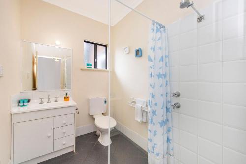 a bathroom with a shower and a toilet and a sink at Holiday on the Terrace in Dunsborough