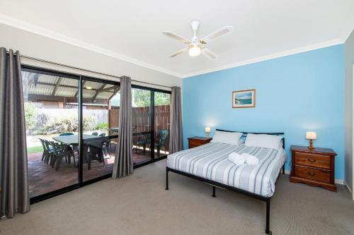 a bedroom with a bed and a dining room at Holiday on the Terrace in Dunsborough
