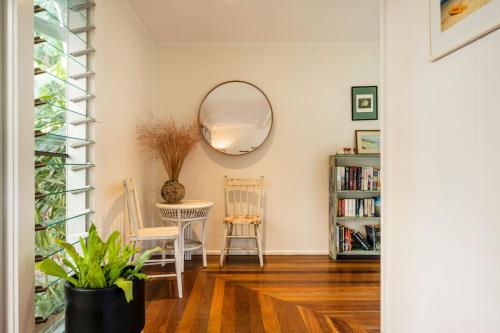 a living room with a mirror and a table at Sea Dip at Iluka in Iluka