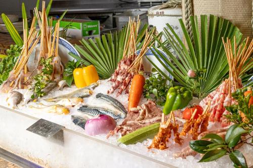 a display of seafood and vegetables on a counter at Xiamen C&D Hotel-Free Welcome Snacks-Oasis Garden in Xiamen