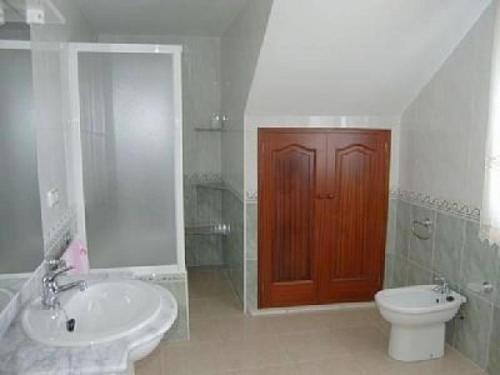 a bathroom with a toilet and a sink and a red door at House - 5 Bedrooms - 00174 in Cacabelos