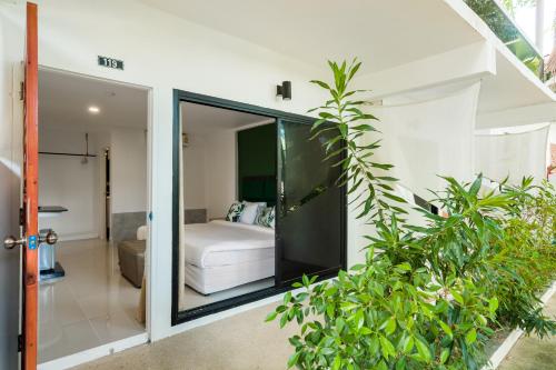 a bedroom in a house with a bed at 4U Resort Samui in Lamai
