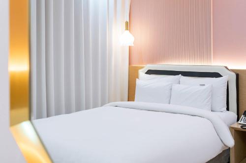 a hotel room with two beds and a telephone at Browndot Hotel Namchuncheon in Chuncheon