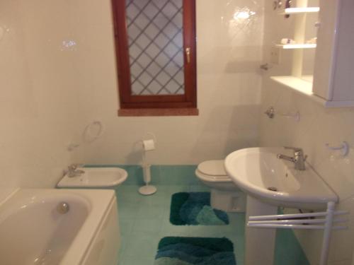 La salle de bains est pourvue de 2 lavabos et de toilettes. dans l'établissement Villa Venturelli, à Tignale