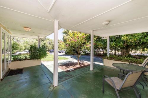 a porch with a table and chairs on it at Busselton River Cottage with WiFi in Busselton