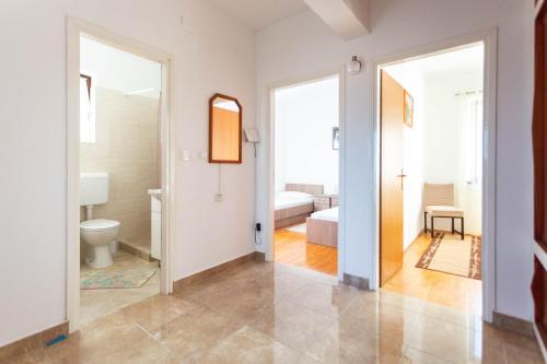 a bathroom with a toilet and a bedroom at Holiday home Milka - in center & close to the sea in Sali