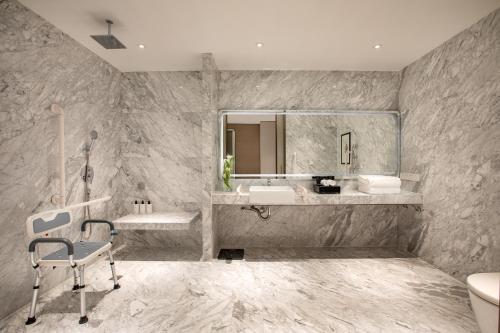 a bathroom with a sink and a mirror at InterContinental Beijing Beichen, an IHG Hotel in Beijing