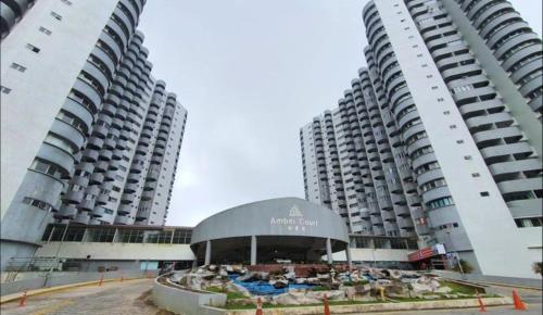 two tall apartment buildings with a pavilion in between them at CloudView Snoopy Theme, Amber Court, Genting Highlands, 1km from Centre, Free Wi-Fi in Genting Highlands