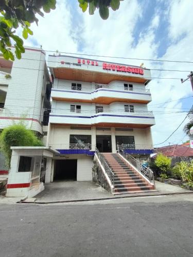 a building with a staircase in front of it at Hotel Riverside Manado in Manado