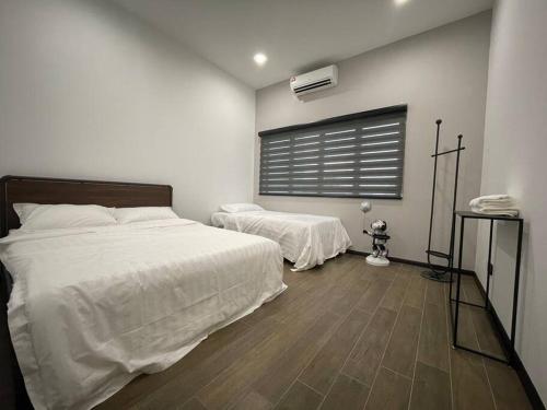 a bedroom with two beds and a window at 5000 SQFT BRAND NEW Semi-D Hype Home 10pax in Ipoh