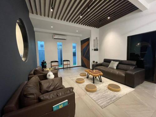 a living room with a couch and a table at 5000 SQFT BRAND NEW Semi-D Hype Home 10pax in Ipoh
