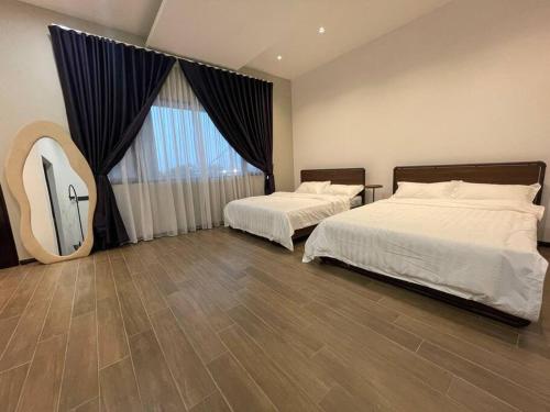 a bedroom with two beds and a large window at 5000 SQFT BRAND NEW Semi-D Hype Home 10pax in Ipoh