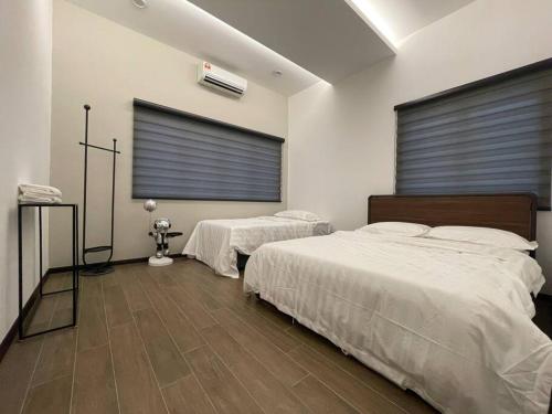 a bedroom with two beds and a window at 5000 SQFT BRAND NEW Semi-D Hype Home 10pax in Ipoh