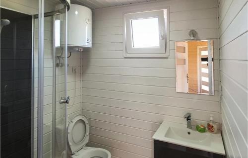 a small bathroom with a toilet and a sink at 2 Bedroom Pet Friendly Home In Jezierzany in Jezierzany