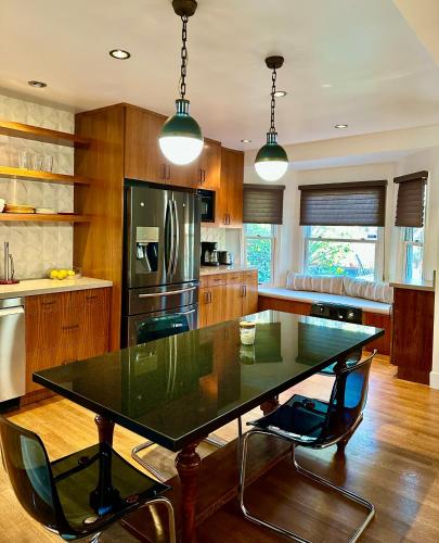 a kitchen with a black table and chairs at Venice Beach Bungalow in Los Angeles