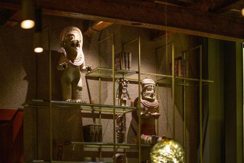 a display case with masks and other items in a room at JW Marriott Quito in Quito