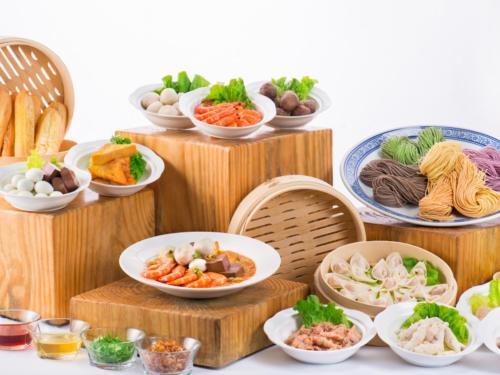 a bunch of bowls of food on wooden plates at Xiamen C&D Hotel-Free Welcome Snacks-Oasis Garden in Xiamen