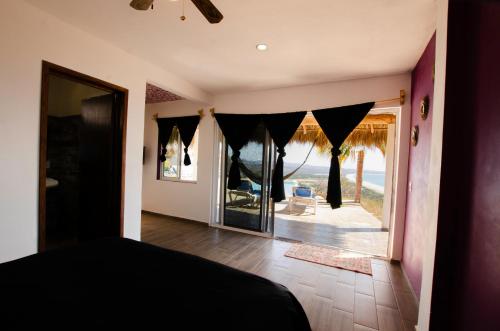 a bedroom with a bed and a view of the ocean at Villas del Sol in Ipala