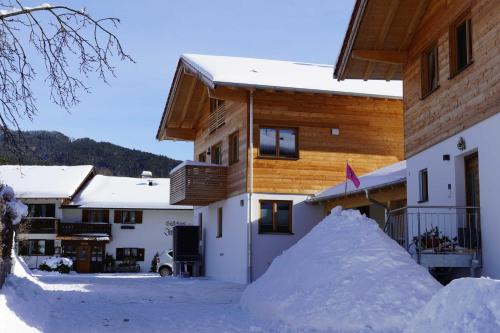 a pile of snow in front of a building at Ferienwohnung Eckmair in Schliersee