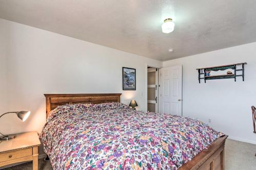 a bedroom with a bed and a table and a lamp at Pet-Friendly Aurora House with Mountain Views! in Salina