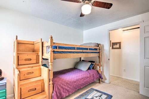a bedroom with bunk beds and a ceiling fan at Pet-Friendly Aurora House with Mountain Views! in Salina
