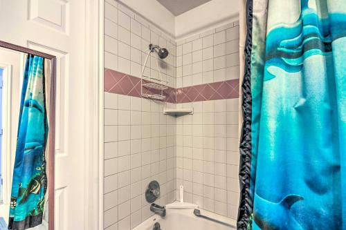 a bathroom with a shower with a blue shower curtain at Pet-Friendly Aurora House with Mountain Views! in Salina