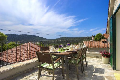 a table and chairs on a balcony with a view at Villa Burica in Vinišće