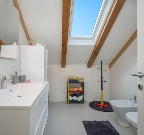a bathroom with a sink and a toilet and a window at Villa Giardino in Drniš