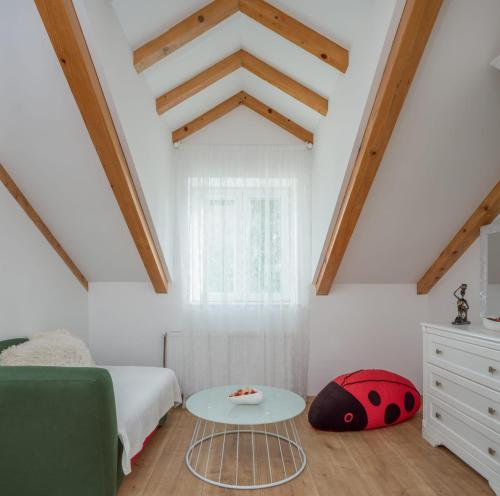 a bedroom with a bed and a table at Villa Giardino in Drniš